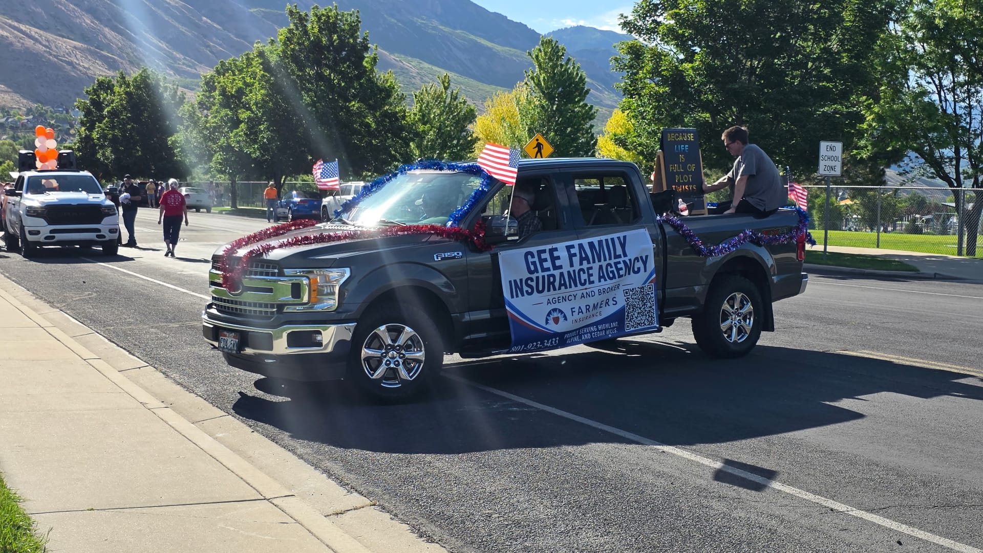 GEE Family Insurance Agency truck decorated with American flags in a Highland, Utah community parade